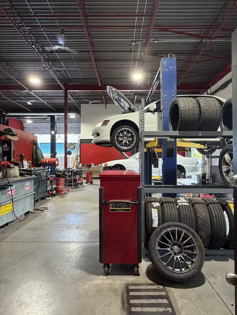 Inside the shop: tire rack and a car on the lift