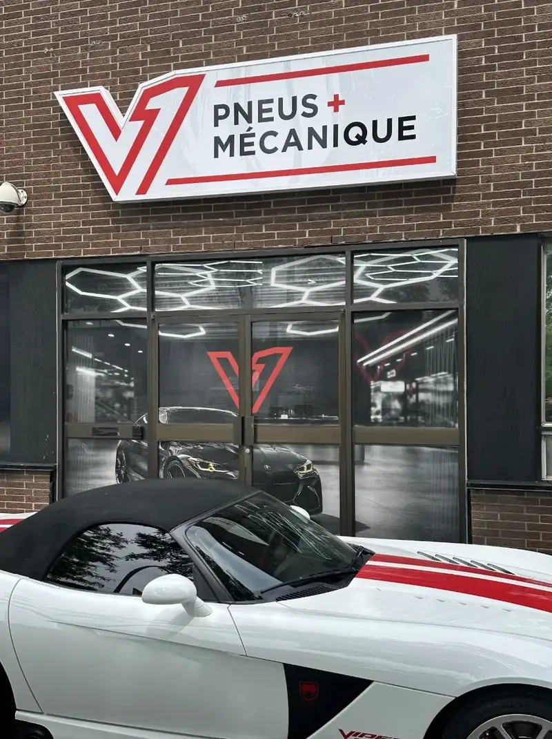 Shop front with the red V1 Pneus + Mécanique sign